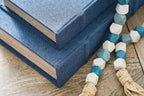 Blue fabric-lidded decorative box with wood-textured sides, close-up view.
