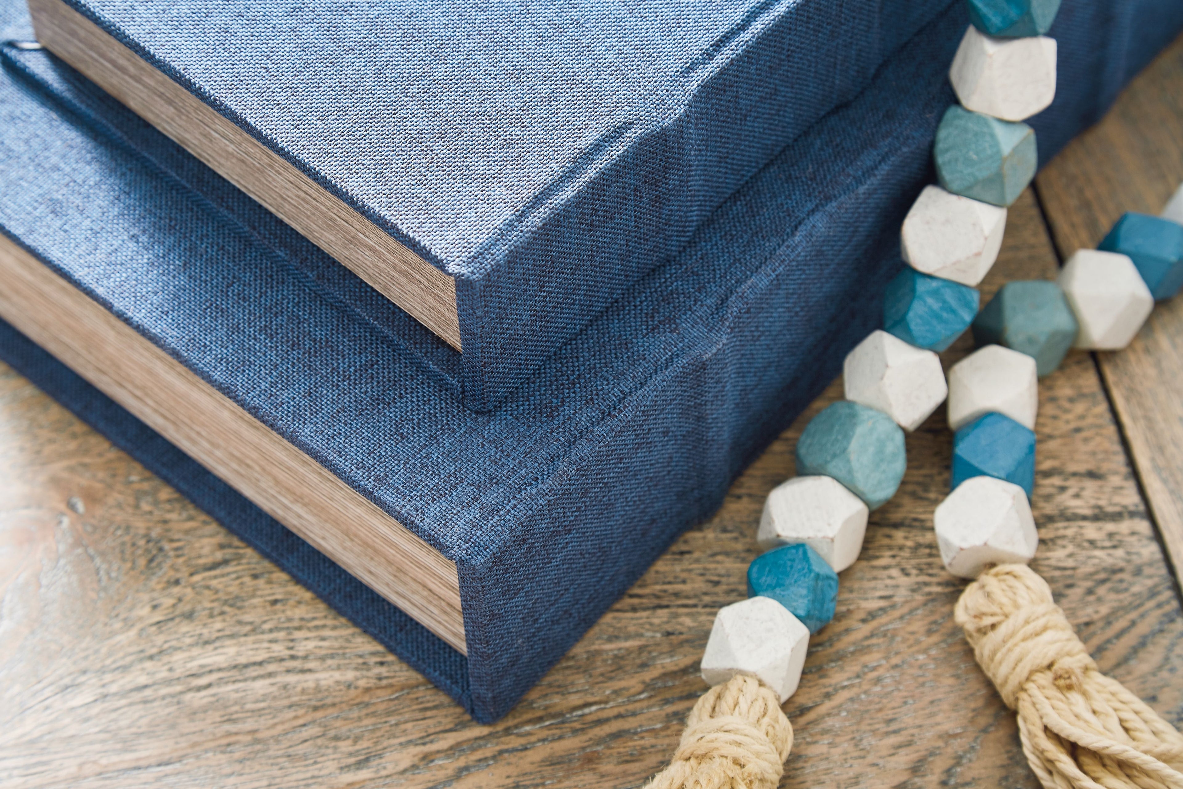 Blue fabric-lidded decorative box with wood-textured sides, close-up view.