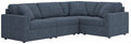 Blue L-shaped sectional sofa with buttonless back cushions and armrests