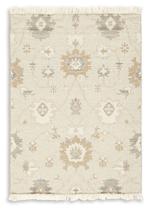 Beige rug with subtle ornate motifs and fringed border, wide view