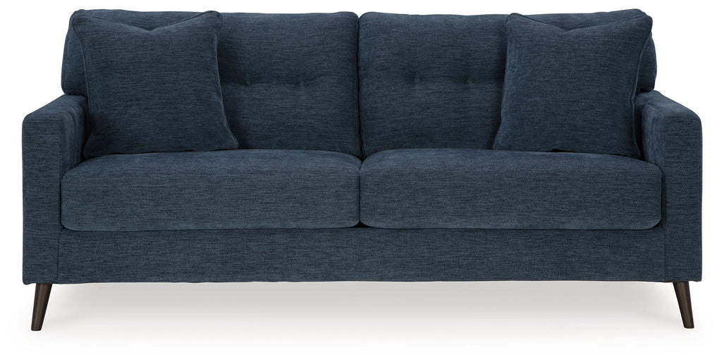 Blue upholstered sofa with three seat cushions and tall back pillows