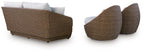 Loveseat and swivel chair set with beige wicker and white cushions, side view