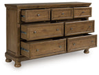 Feddinger medium brown wooden dresser with drawers pulled out and metal pulls