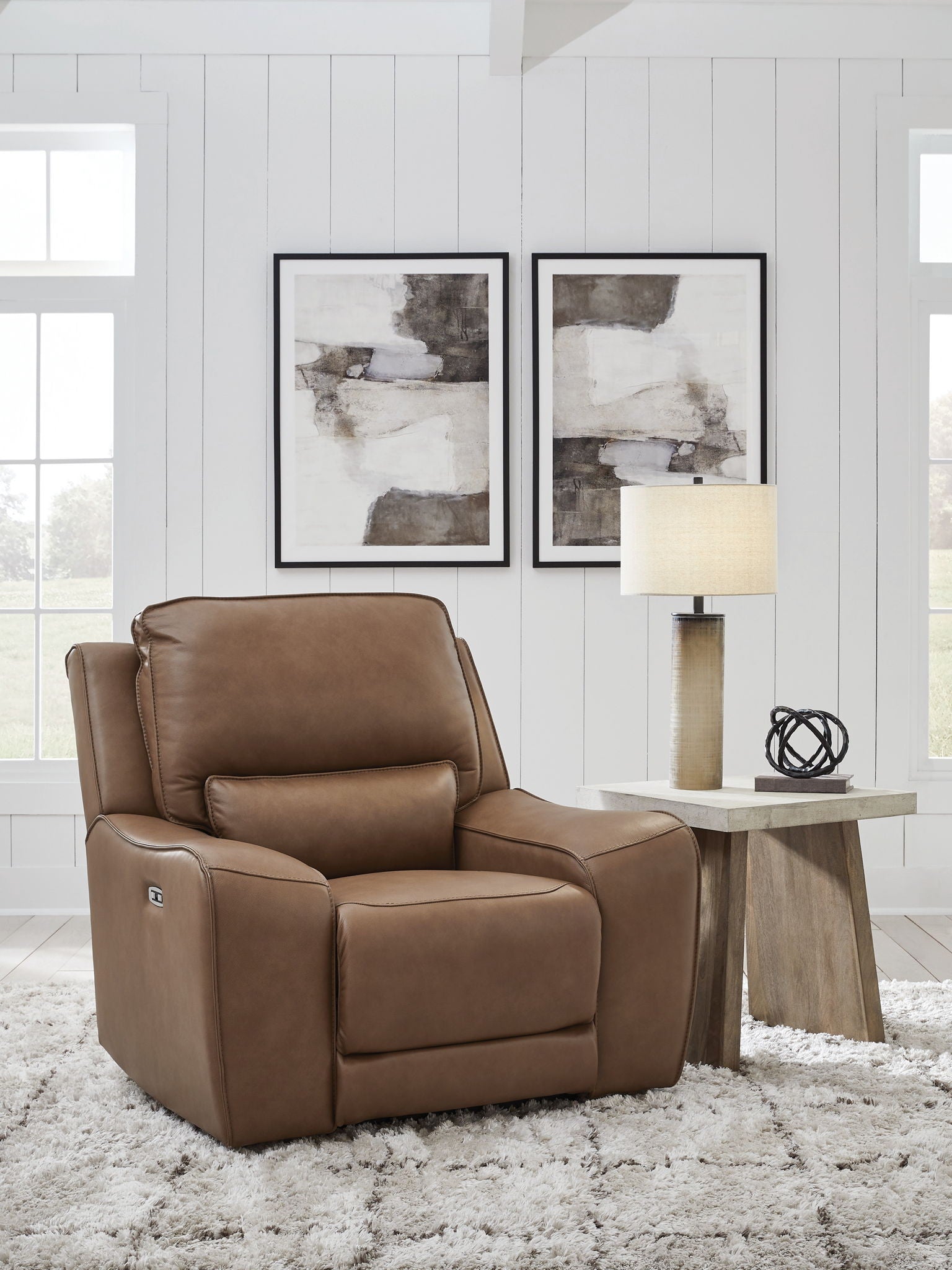 Caramel power recliner chair with tall padded headrest and cushioned seat, wide armrests
