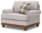 Sandstone light-gray chair and a half with plaid throw pillow and rolled arms