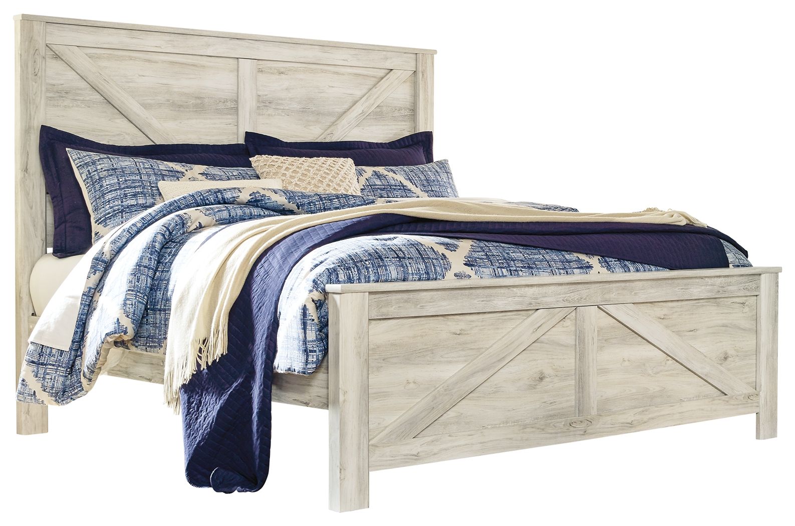 Beige crossbuck panel bed with blue and white quilt and navy pillows