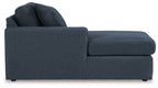Ink blue corner chaise with tufted-look cushions and rolled back pillows