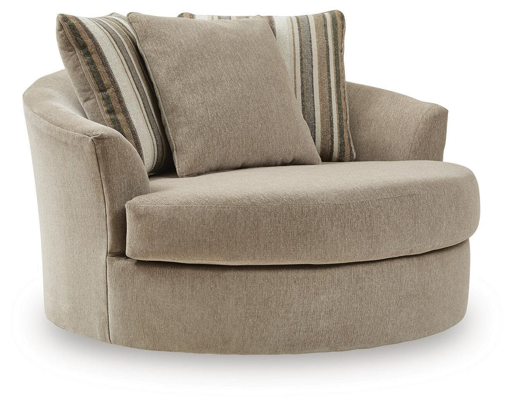 Oversized accent chair in beige fabric with two striped back cushions and rounded arms.