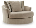 Oversized accent chair in beige fabric with two striped back cushions and rounded arms.