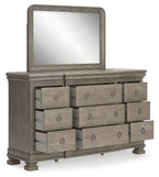 Gray dresser with tall mirror and six front drawers with oval pulls