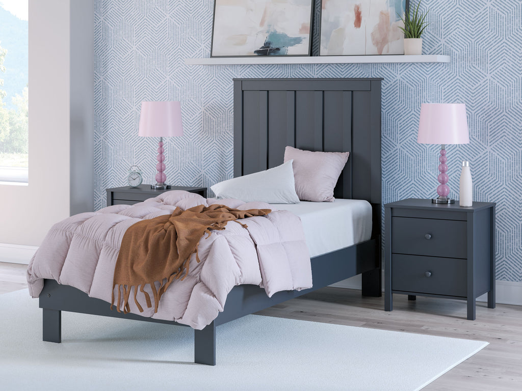 Blue platform bed with panel headboard, white bedding and decorative pillows