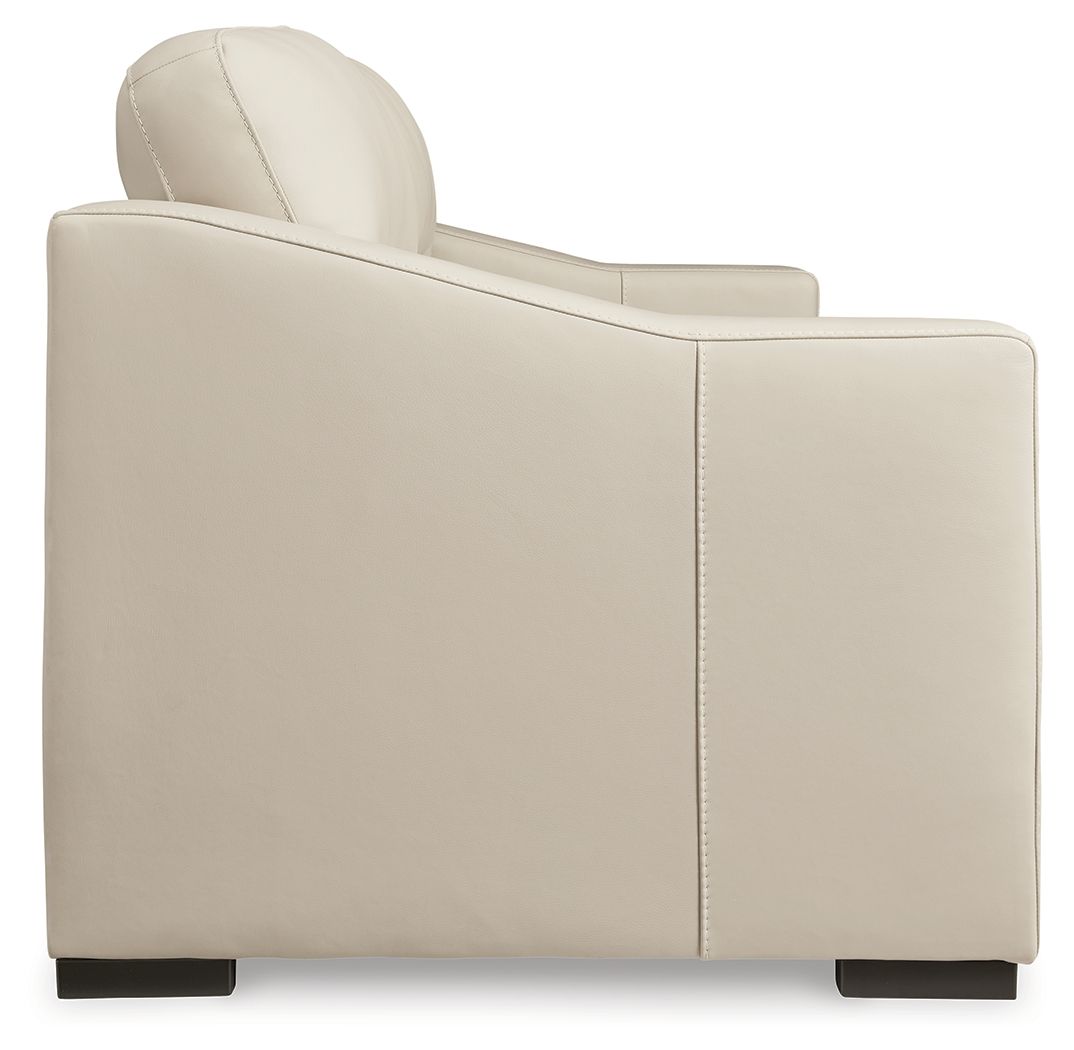 Almond upholstered sofa with tall back cushion and wide arm panel