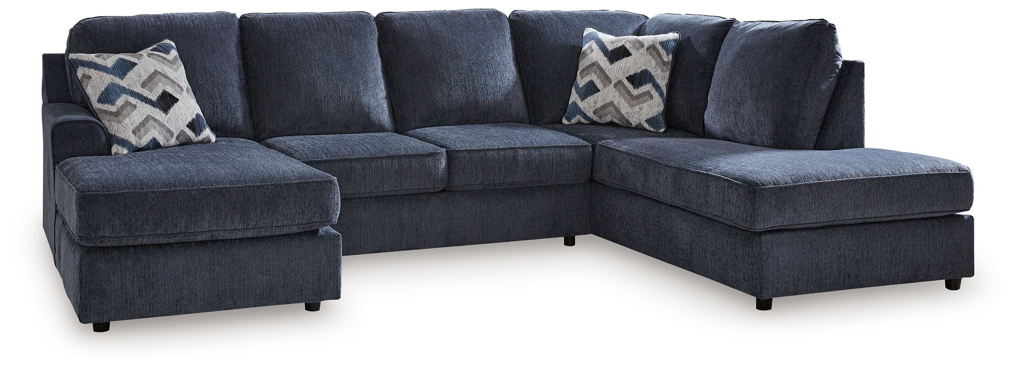 Blue sectional sofa with two ottoman benches and patterned accent pillows
