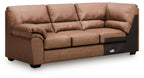 Caramel upholstered sofa with corner wedge, tufted cushions and rolled armrests