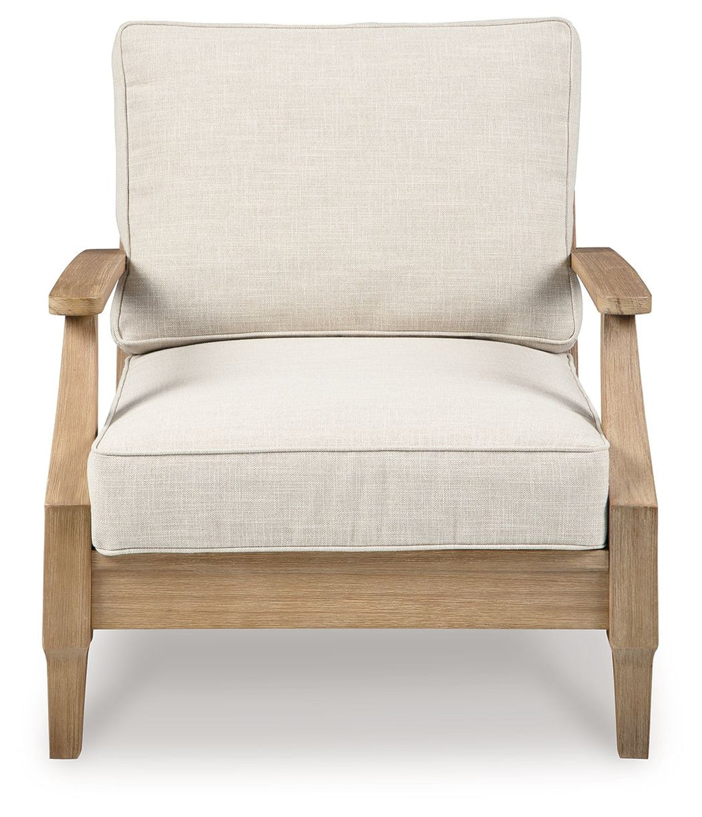 Beige lounge chair with cushion, padded seat and back, light wood frame and arms.