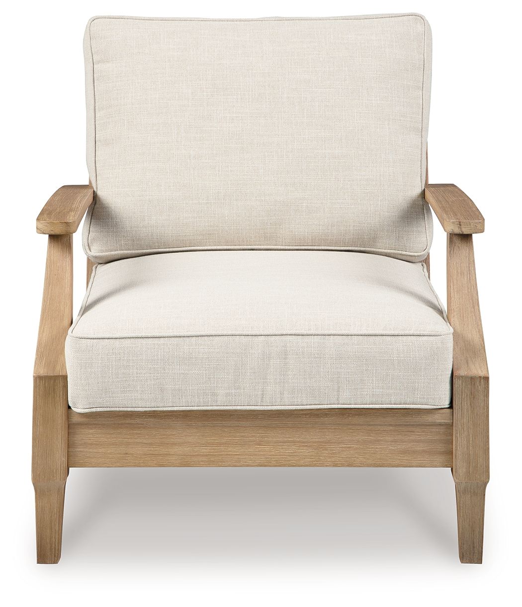 Beige lounge chair with cushion, padded seat and back, light wood frame and arms.