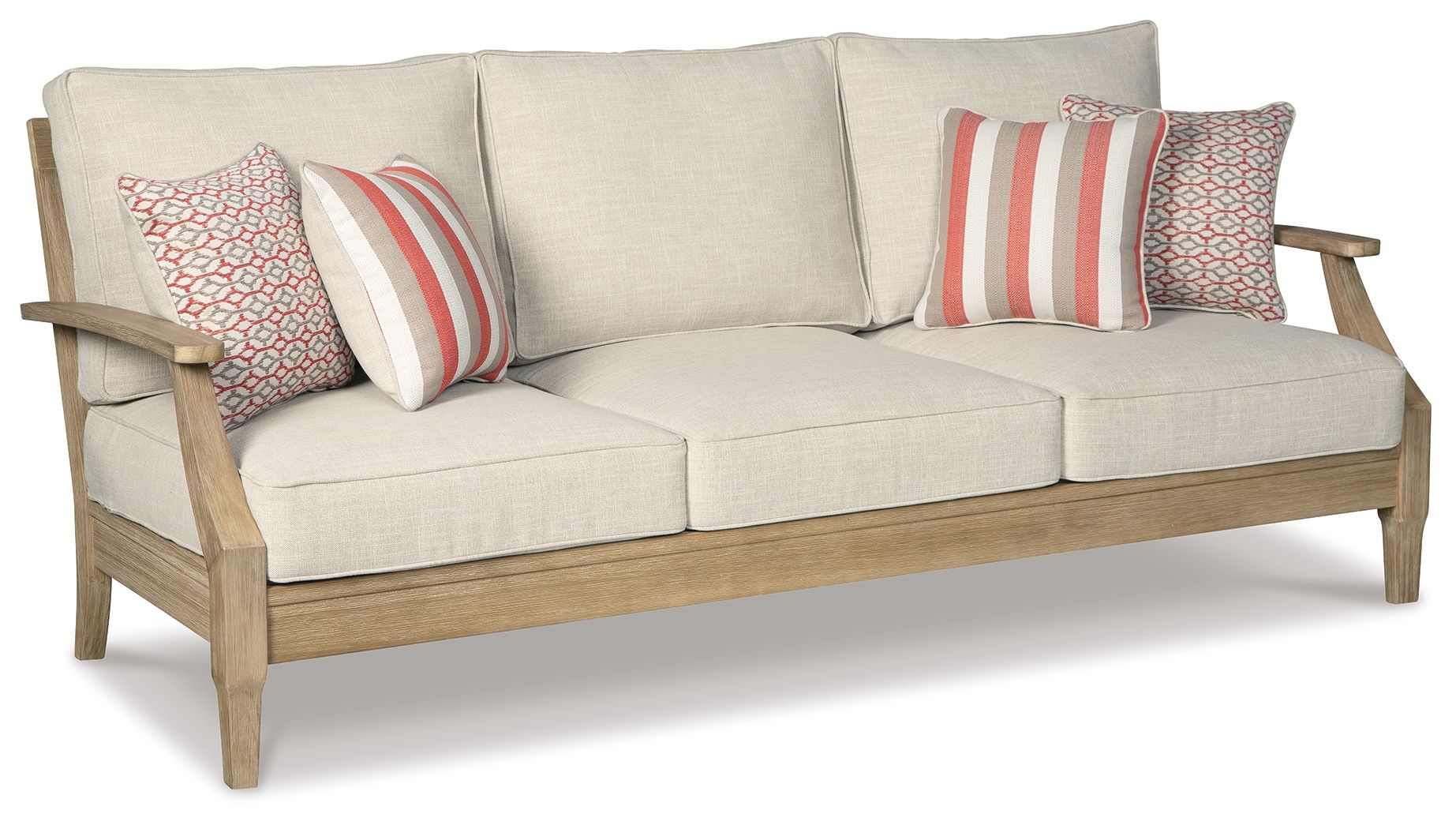 Beige sofa with three seat cushions and four decorative pillows