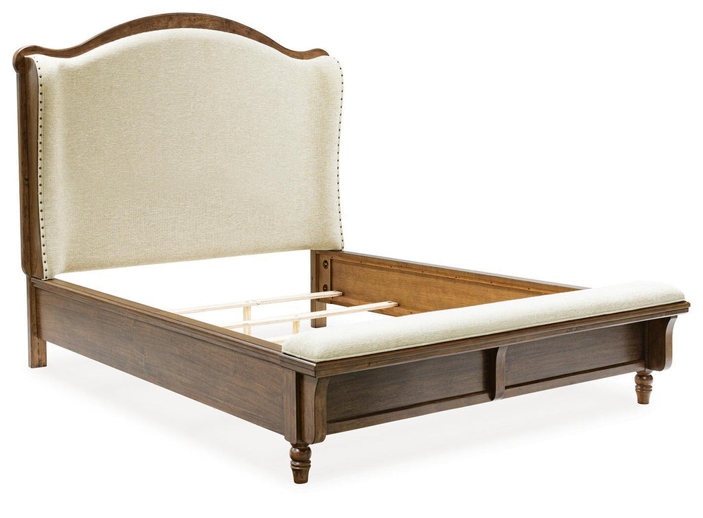 Upholstered panel bed with cream headboard and dark brown wooden frame, slatted base