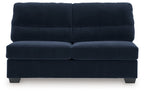 Navy armless loveseat with segmented back cushions, padded seat, and low block legs.