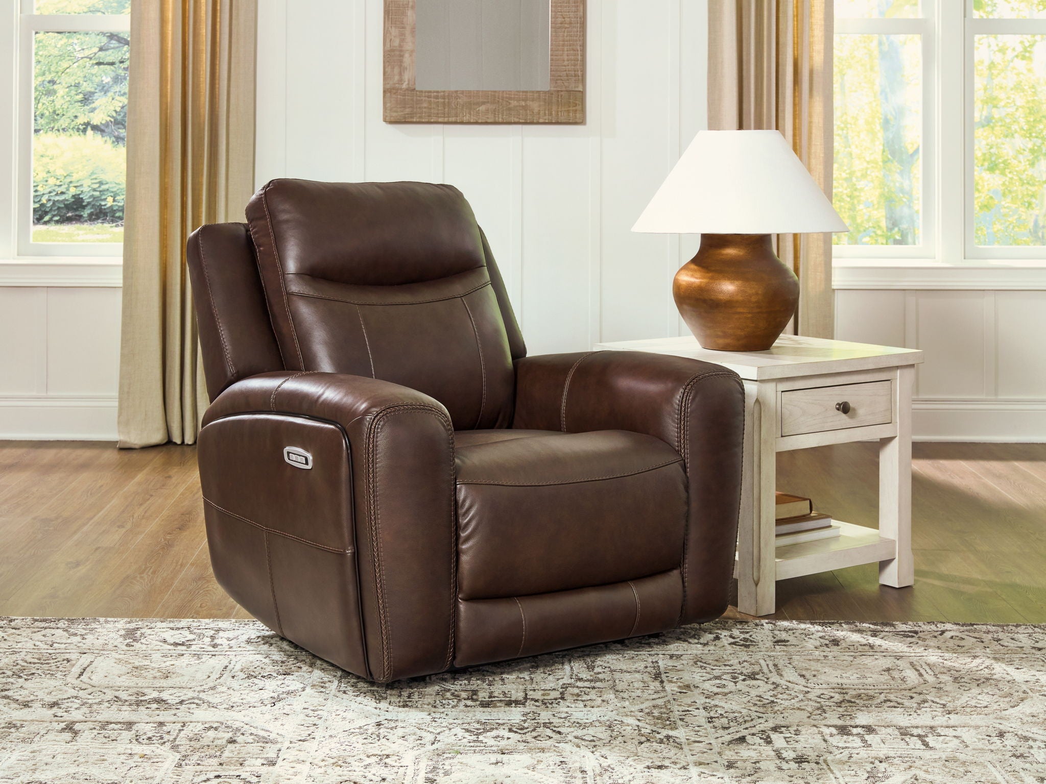 Brown power recliner with adjustable headrest and smooth padded seat