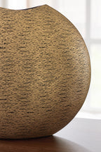 Gold textured vase shown from side, with dark top opening
