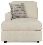 Pearl silver corner chaise with brick-pattern lumbar pillow and rounded arms