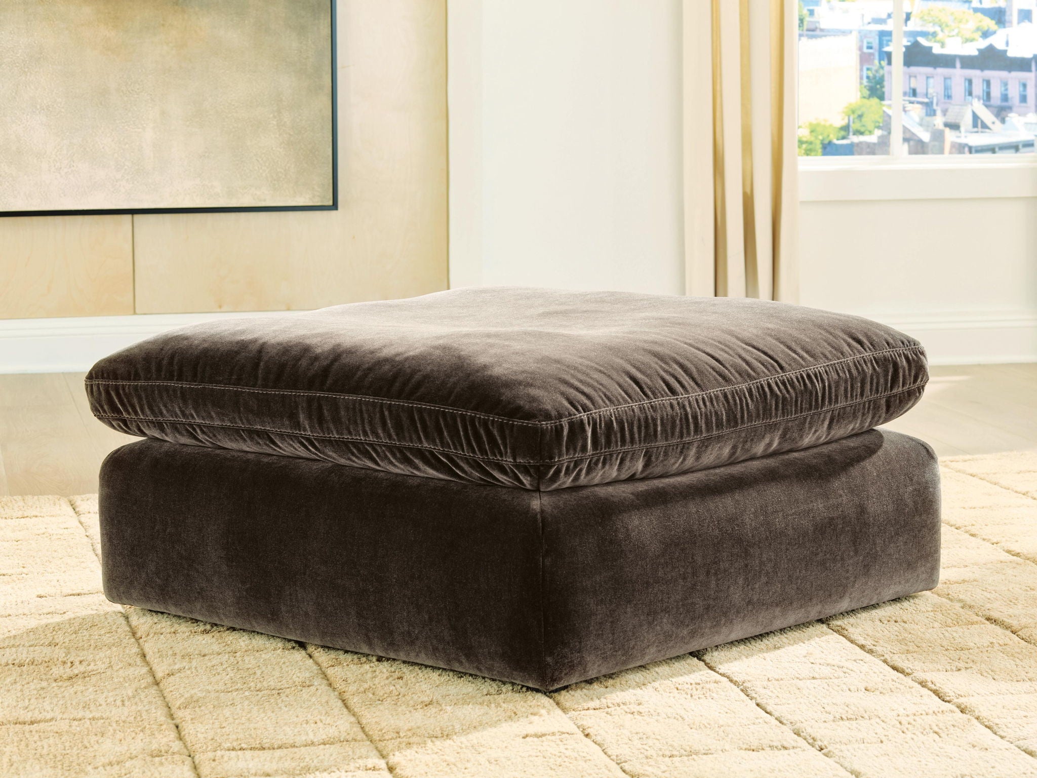 Oversized accent ottoman in dark brown, square frame with padded top cushion