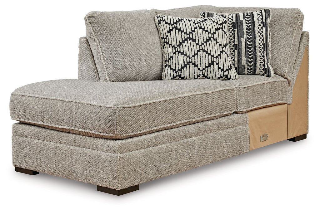 Gray corner chaise with upholstered arm and two patterned accent pillows