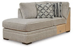 Gray corner chaise with upholstered arm and two patterned accent pillows