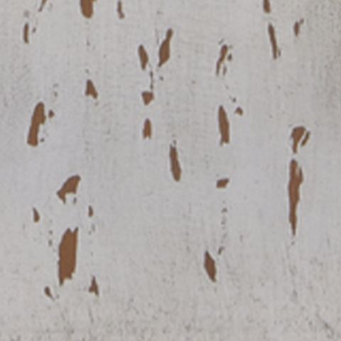Close-up of distressed white painted finish with scattered brown flecks