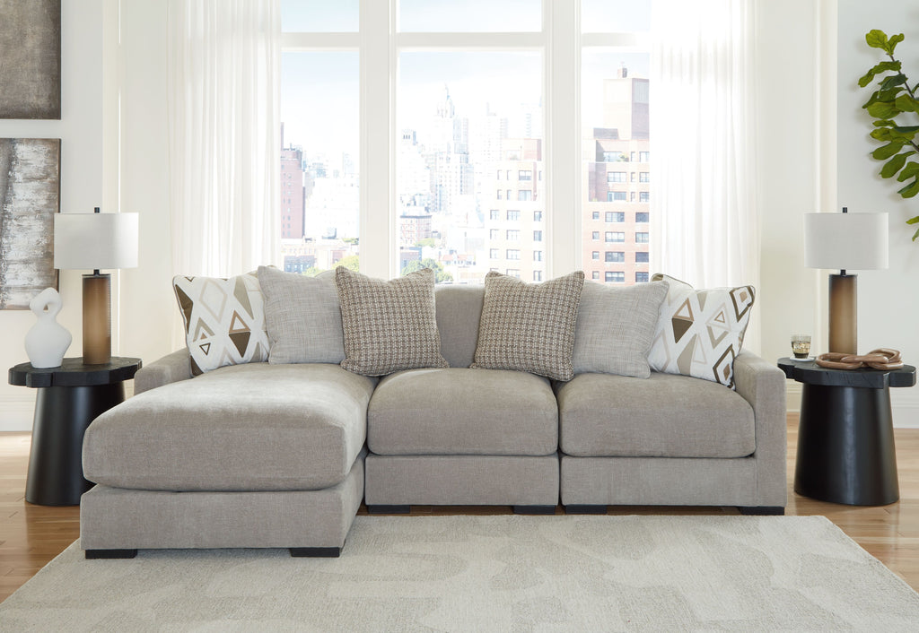 Light gray sectional sofa with extended chaise seats and patterned throw pillows