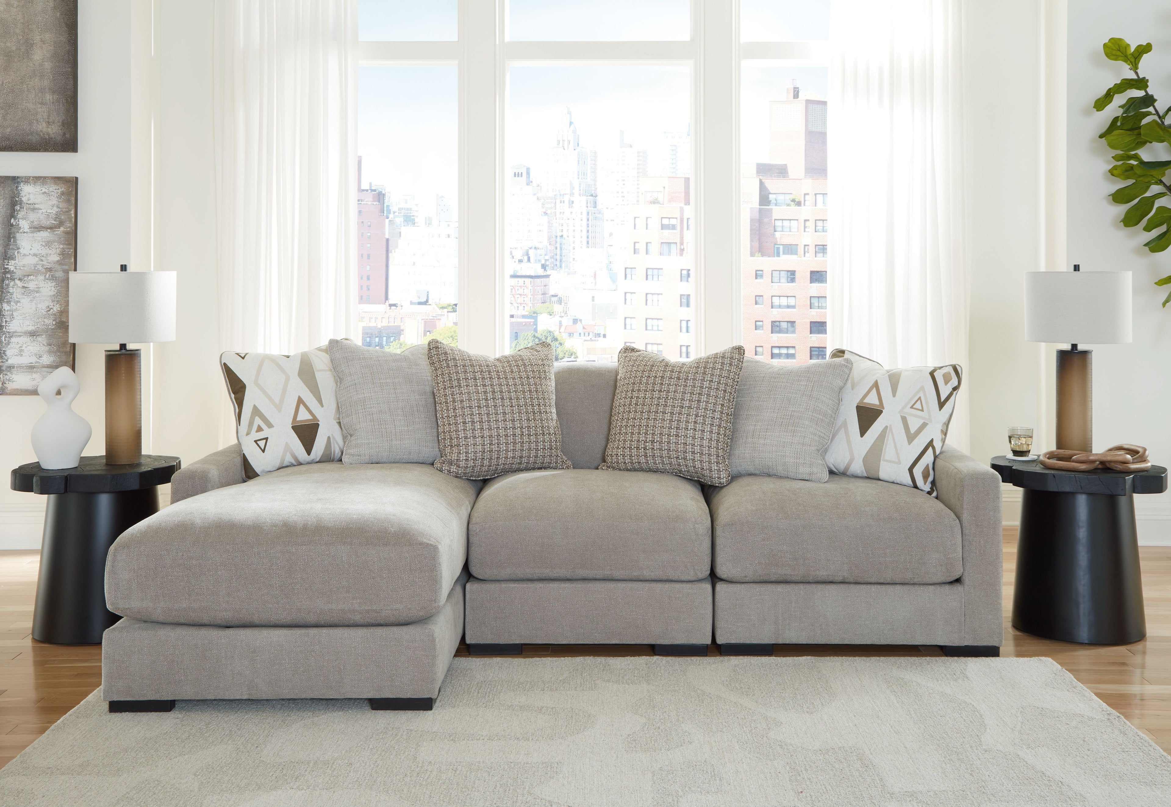Light gray sectional sofa with extended chaise seats and patterned throw pillows
