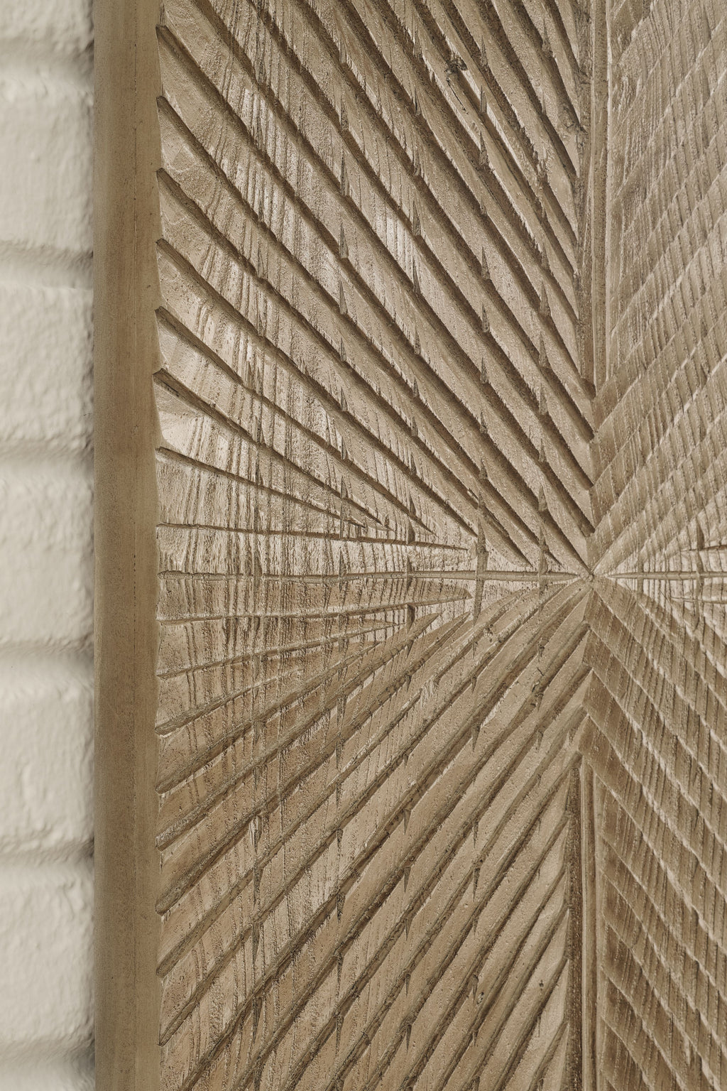 Distressed brown wall decor panel detail with radiating chevron grooves