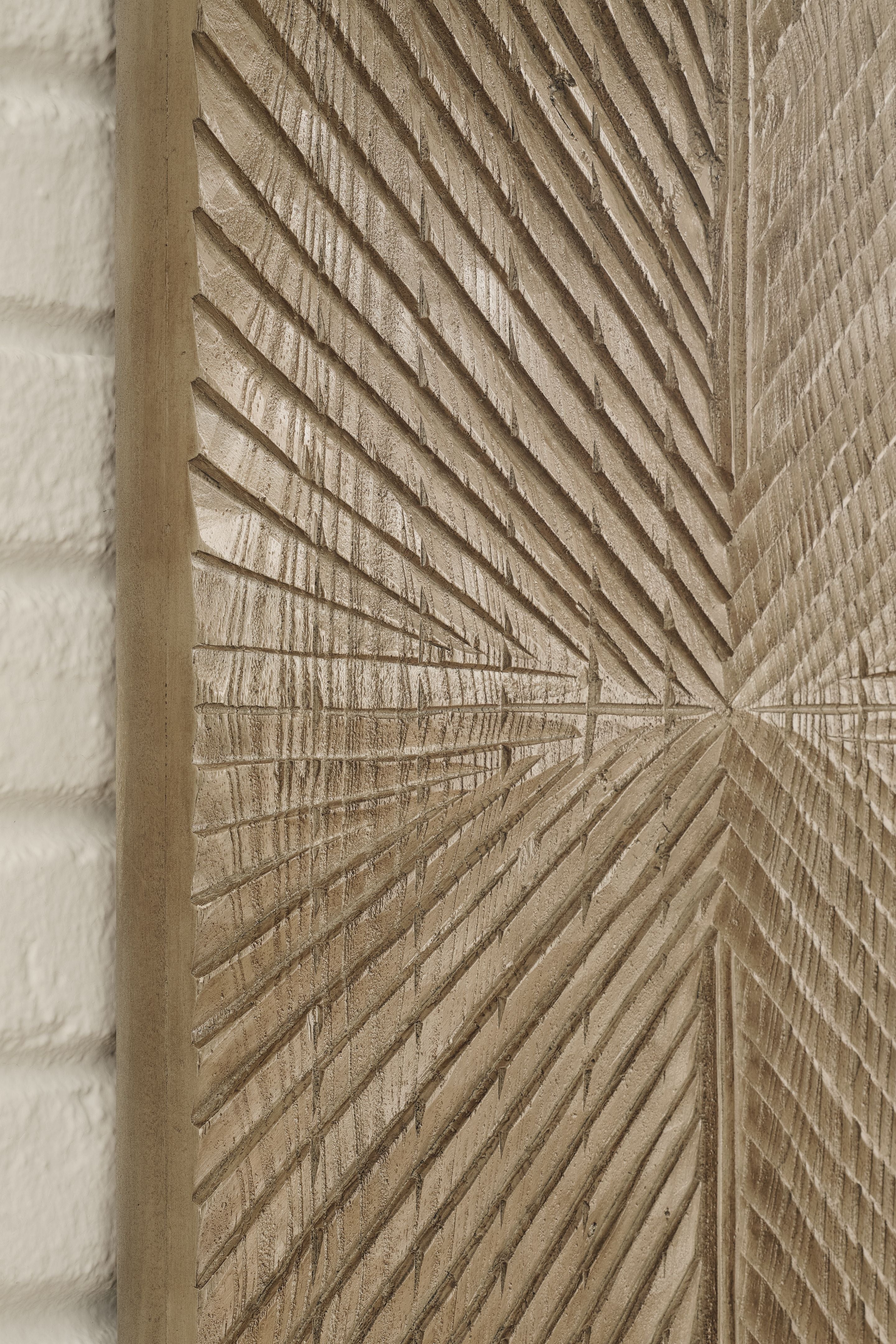 Distressed brown wall decor panel detail with radiating chevron grooves