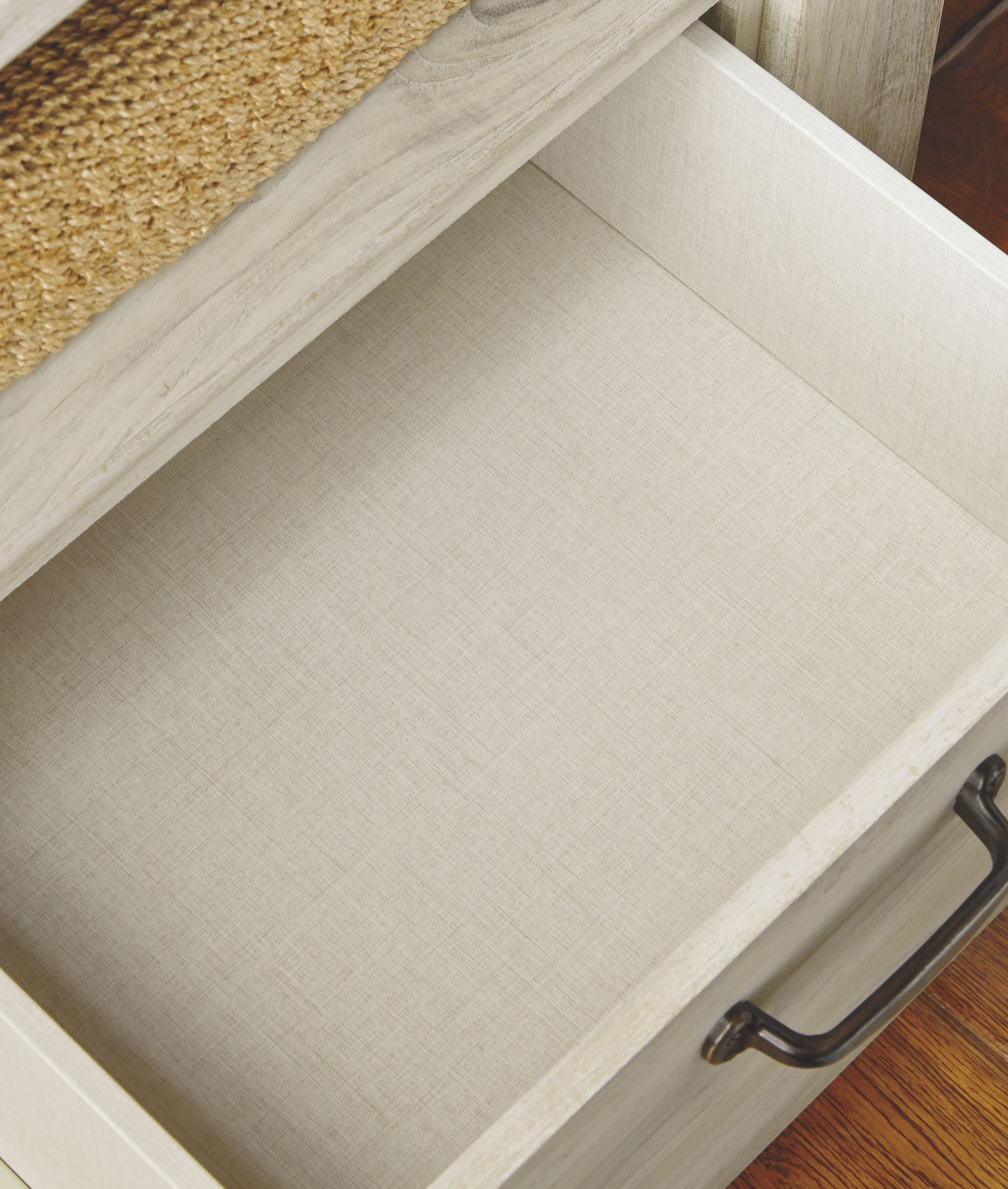 Whitewash drawer interior with light fabric lining and metal pull handle