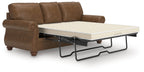 Dark brown sofa sleeper with pull-out mattress base and padded armrests