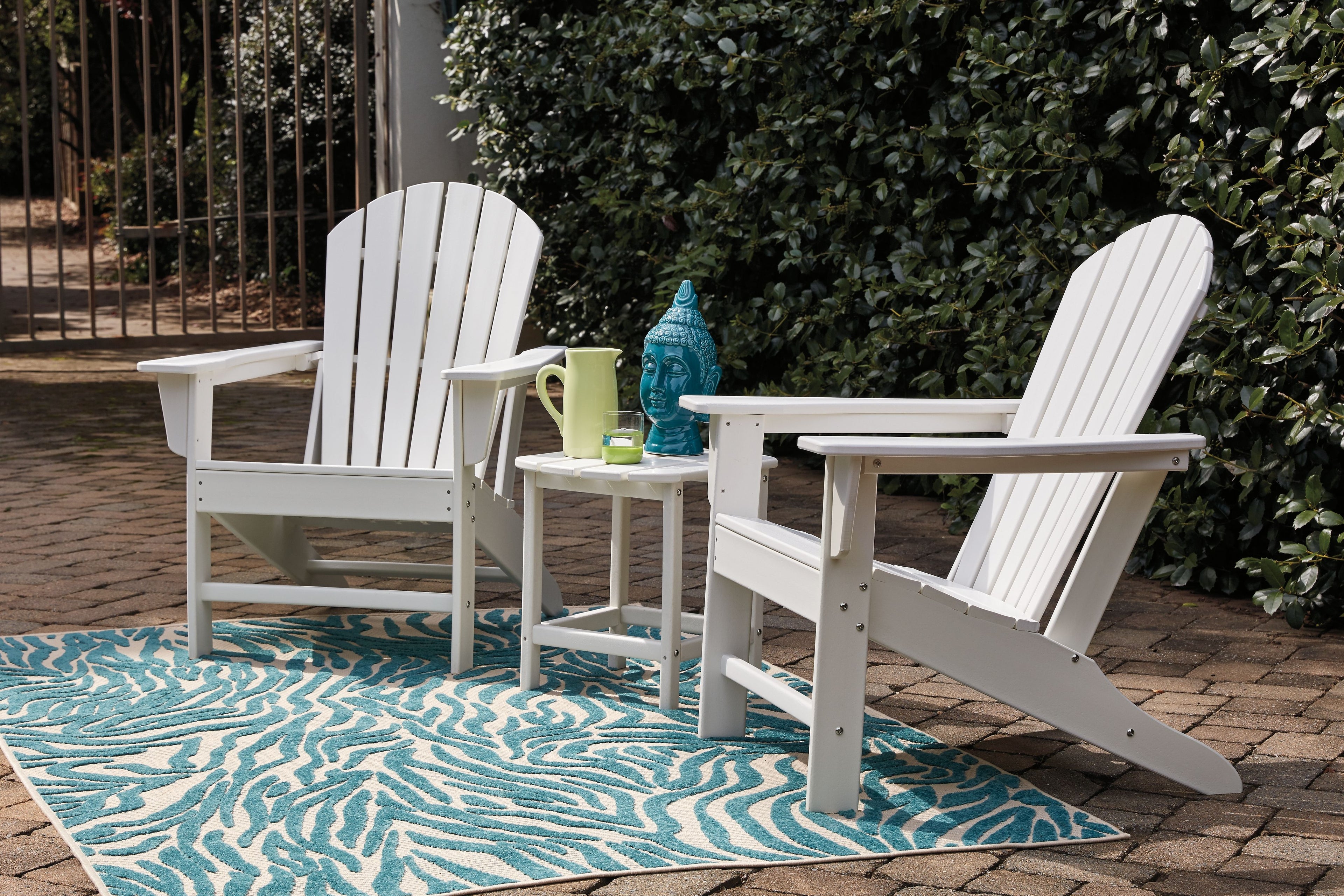 White outdoor conversation set: two Adirondack chairs and rectangular side table