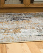 Abstract area rug close-up with low pile and cream, blue-gray, rust flecks