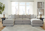 Light gray sectional sofa with two ottoman-style chaise sections and patterned cushions