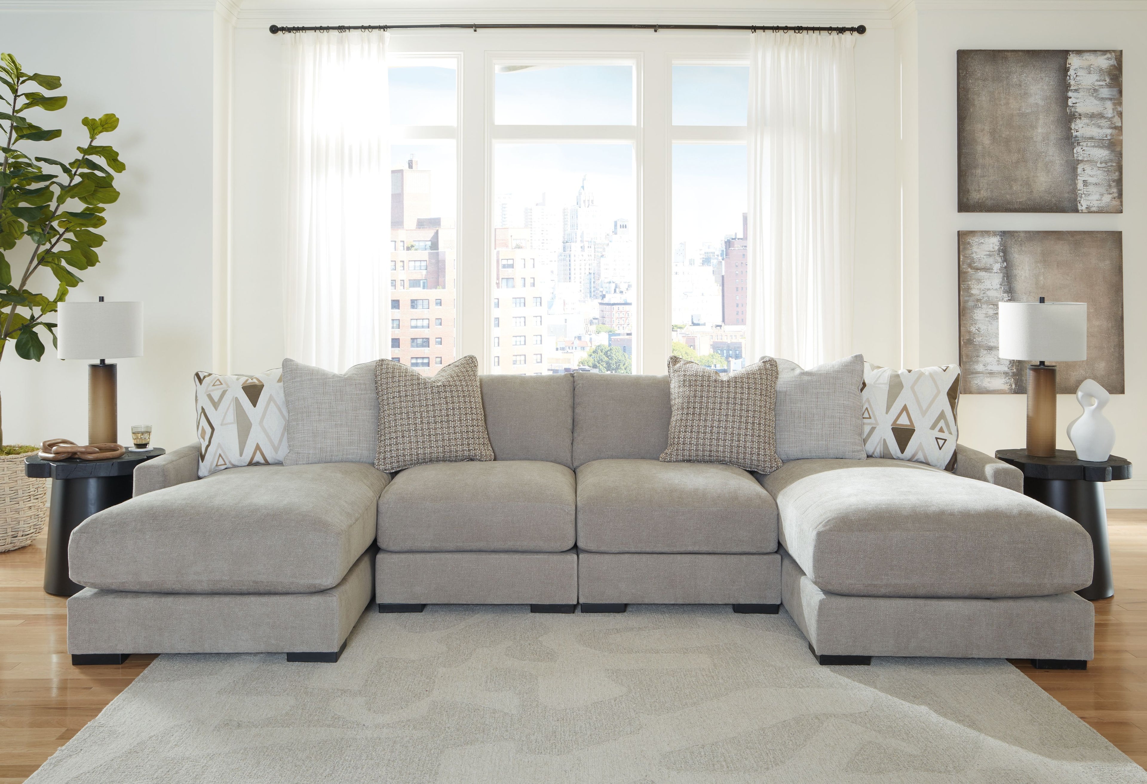 Light gray sectional sofa with two ottoman-style chaise sections and patterned cushions