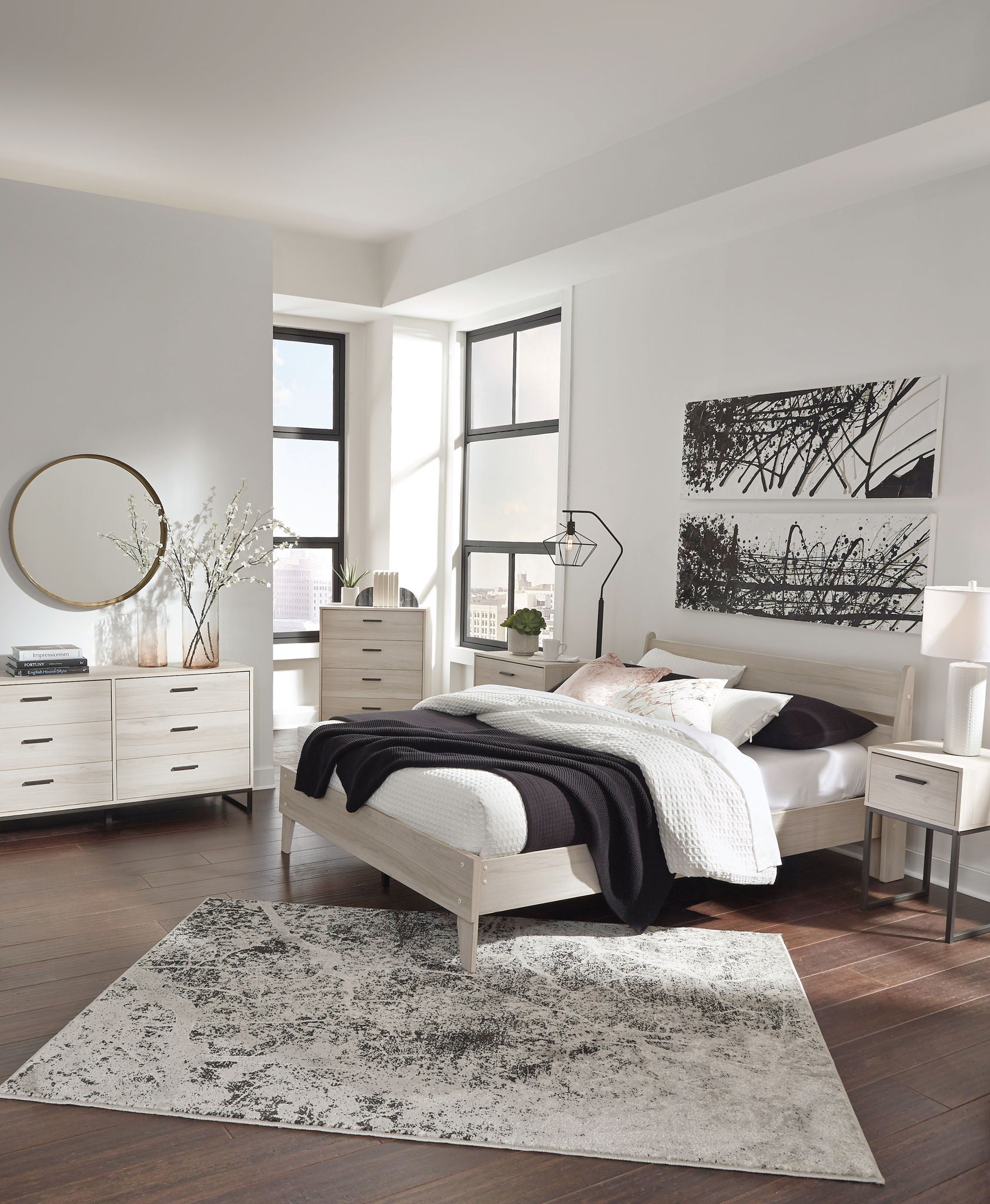 Bedroom set with light bed frame, dresser with mirror, and two bedside tables