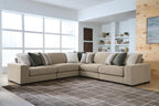 Light brown sectional sofa with chaise corner and striped decorative pillows