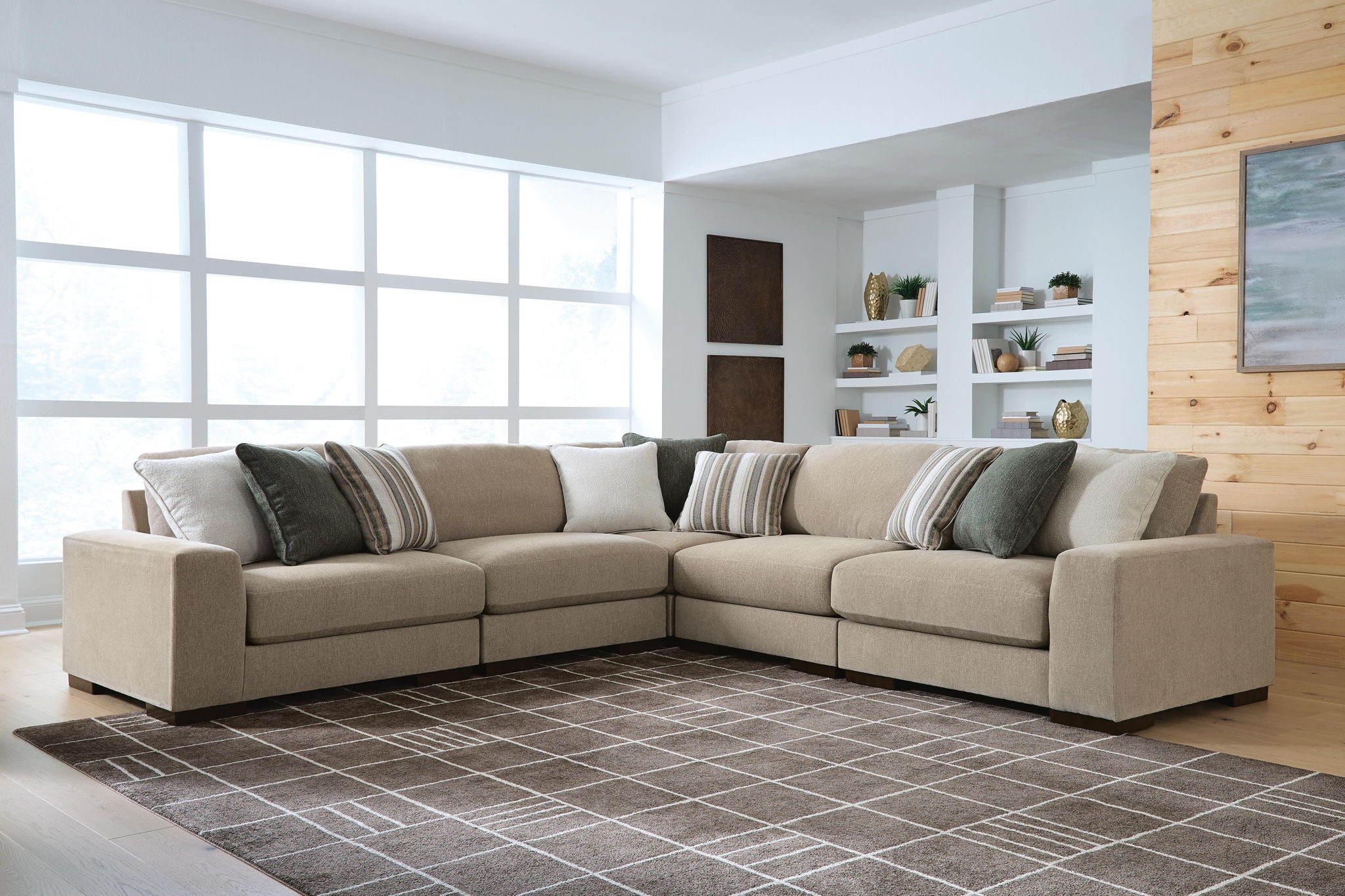Light brown sectional sofa with chaise corner and striped decorative pillows