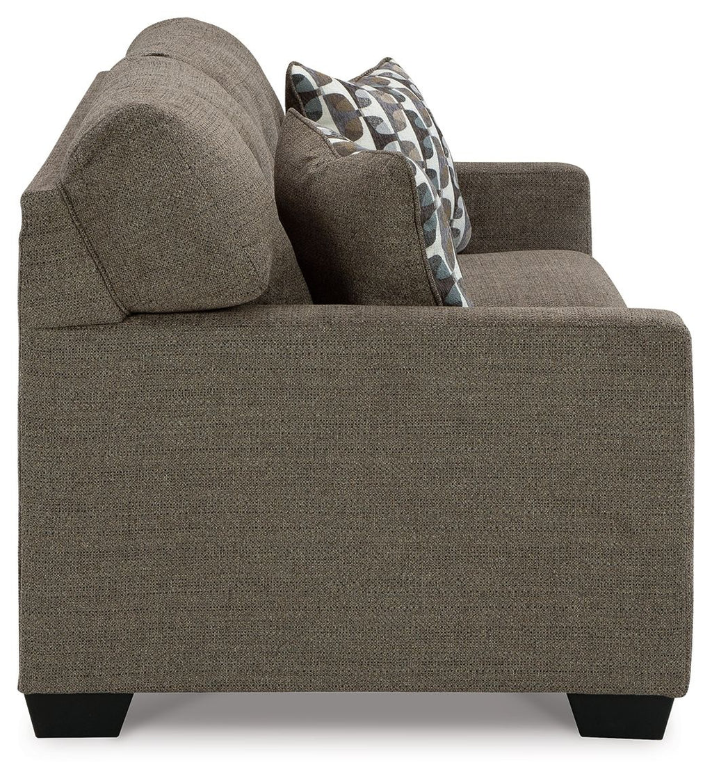 Chocolate sofa sleeper side view with patterned accent pillows and tapered feet