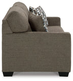 Chocolate sofa sleeper side view with patterned accent pillows and tapered feet