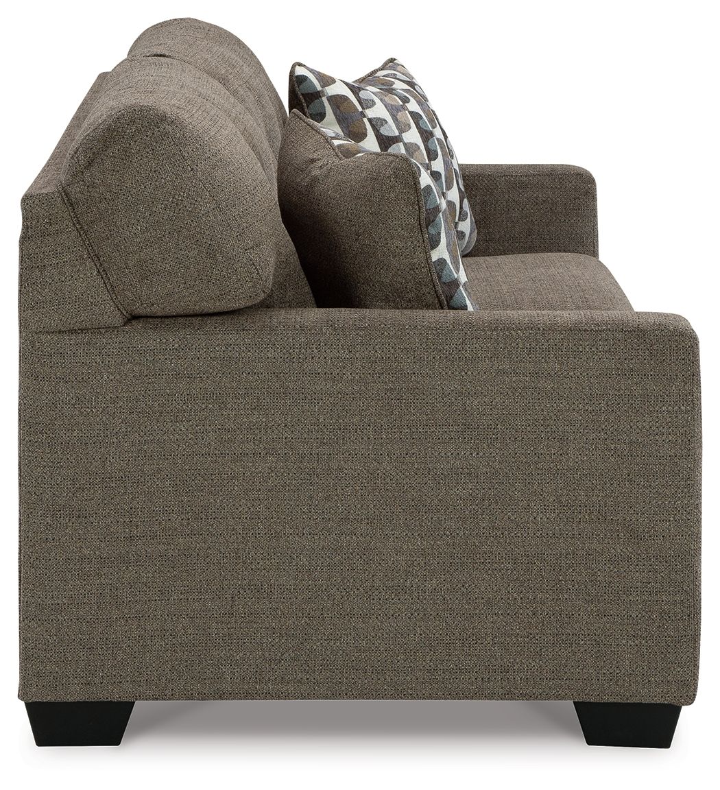 Chocolate sofa sleeper side view with patterned accent pillows and tapered feet