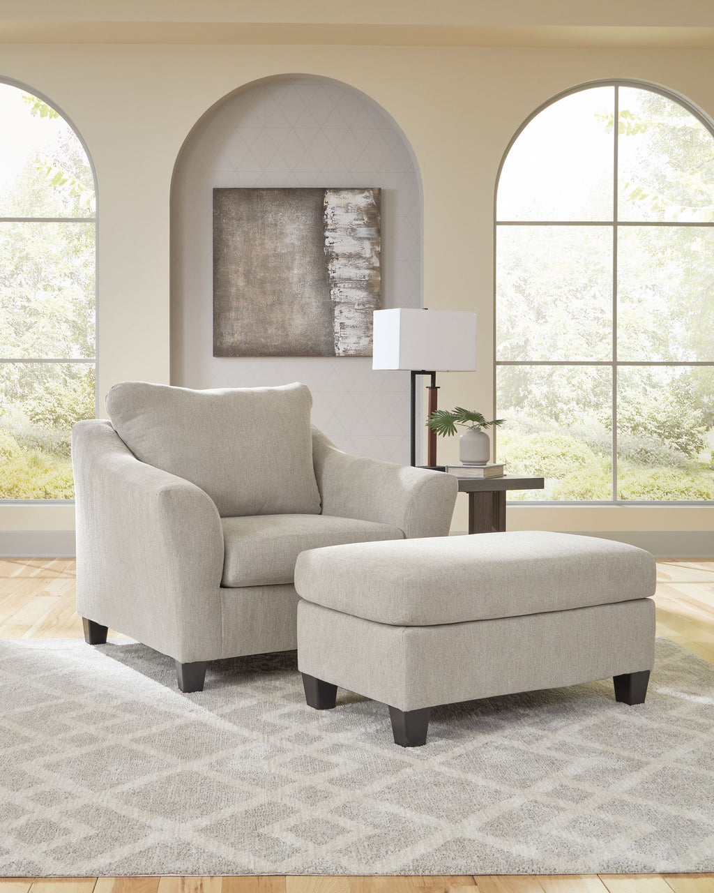 Taupe upholstered chair and a half with matching ottoman and dark legs