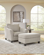 Taupe upholstered chair and a half with matching ottoman and dark legs