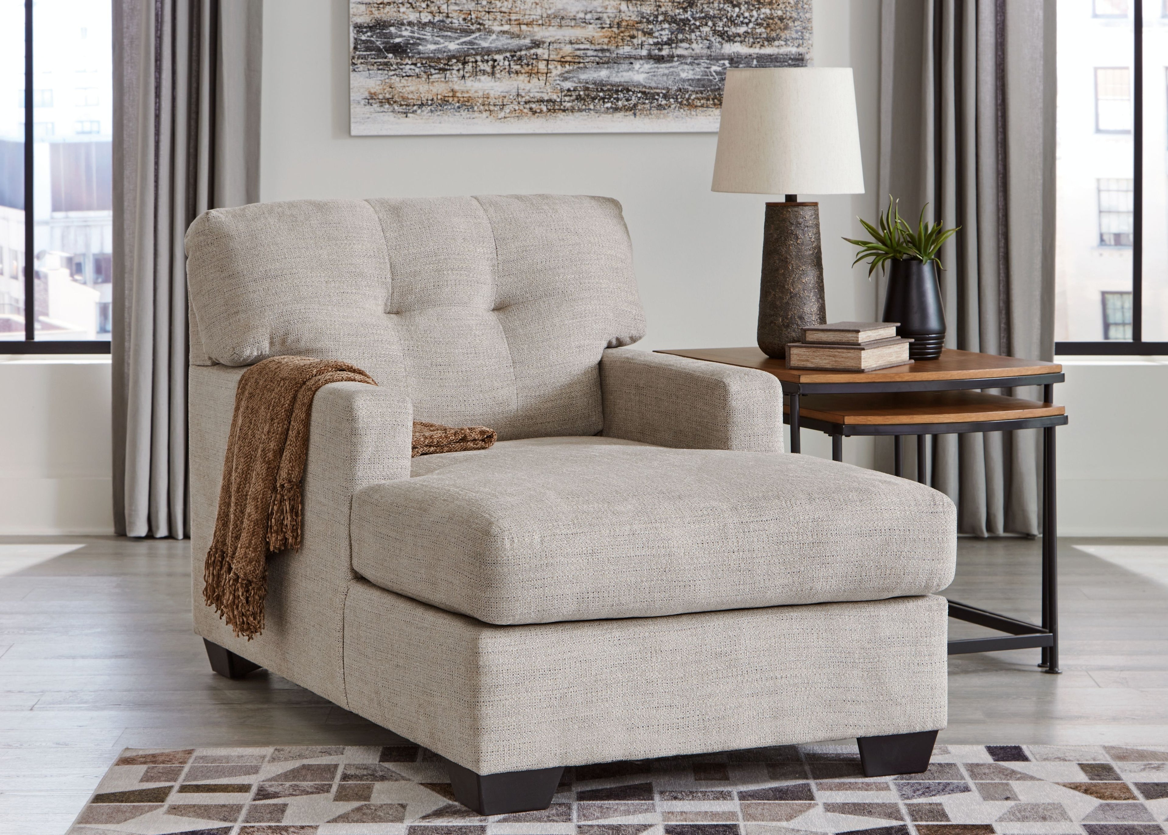 Pearl silver chaise lounge chair with tufted back, track arms, and black feet