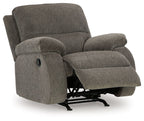 Dark gray rocker recliner chair with recline base visible beneath the seat